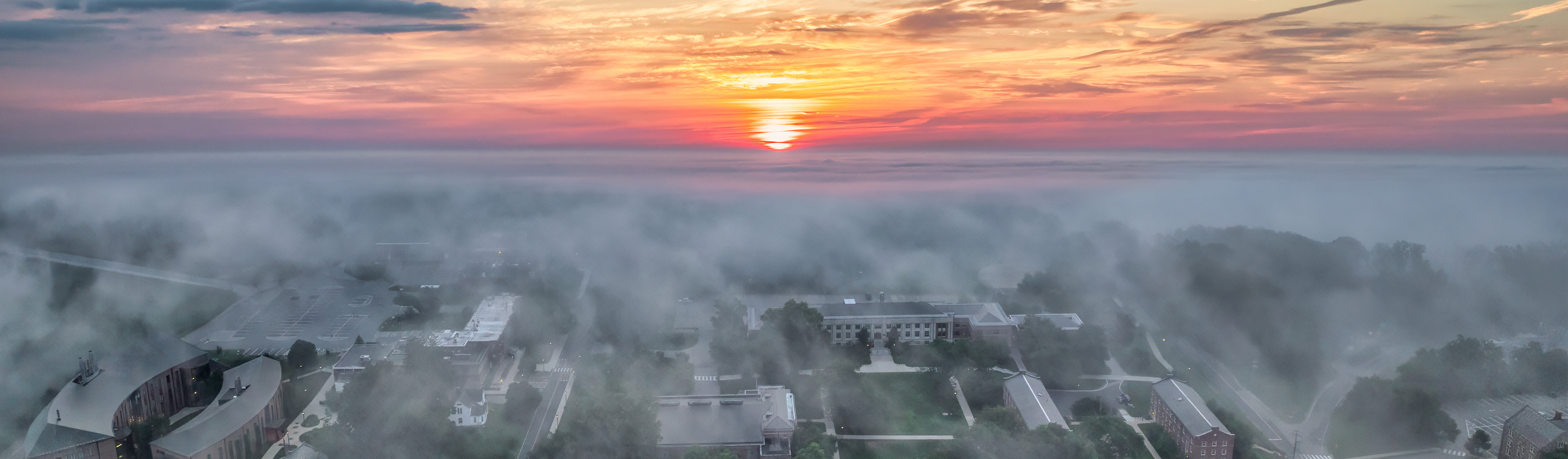 aerial view of campus through morning fog